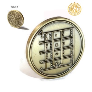May include: A gold-colored coin with a design of a ladder and Hebrew text on one side. The other side of the coin has a circular design with Hebrew text.