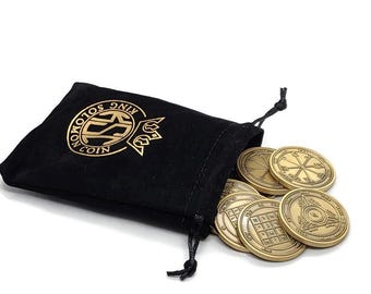 May include: A black velvet pouch with gold lettering that reads "King Solomon Coin" is open, revealing a set of gold-colored metal coins with intricate designs.