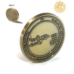 May include: A gold-colored coin with a design of a hand pointing to a series of Hebrew letters. The coin is inscribed with the words "Confundantur qui oma" and "paverse" in Hebrew. The coin also features a Star of David and the words "King Solomon Coin".