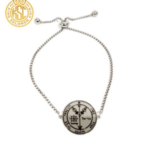 May include: A silver adjustable bracelet with a round pendant featuring a silver sigil with Hebrew text and symbols.