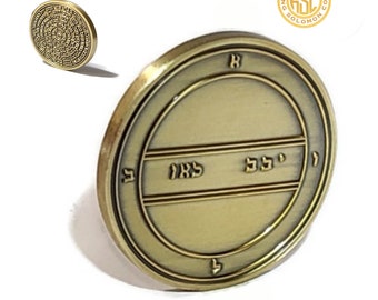 May include: A gold-colored metal coin with Hebrew writing on it. The coin has a raised rim and a smooth surface. The writing on the coin says "King Solomon Coin".