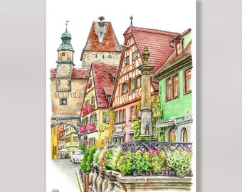 May include: Watercolor painting of a European townscape with colorful buildings, red tile roofs, and a clock tower. The artwork features a street scene with a fountain, flowers, and the text "ArtifulJulia".