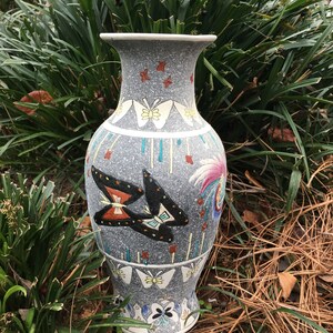 vase adorned with butterflies