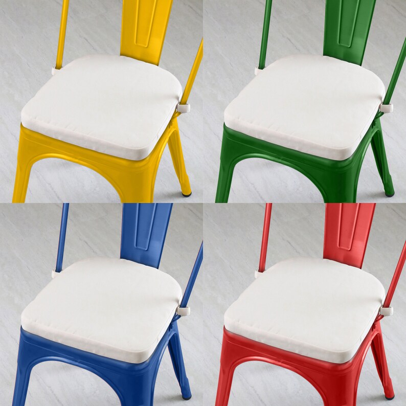 May include: Four colorful metal chairs with white seat cushions. The chairs are painted in yellow, green, blue, and red. The chairs have a classic industrial design, with a slatted back and a sturdy frame.