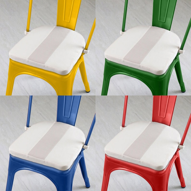 May include: Four colorful metal chairs: yellow, green, blue, and red. Each chair has a white seat cushion with a light gray stripe down the center. The chairs have a classic industrial design.