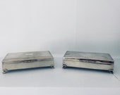 Pair of Vintage Aristocrat H.E.P.N.S.B England silver plated cigarette boxes cases - footed smoking storage set