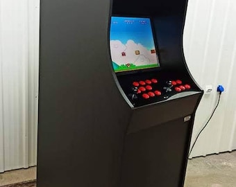 May include: A black arcade machine with a screen displaying a video game. The machine has red buttons and joysticks for gameplay. The top of the machine features a colorful graphic with the word "Arcade" and the word "Simulators".