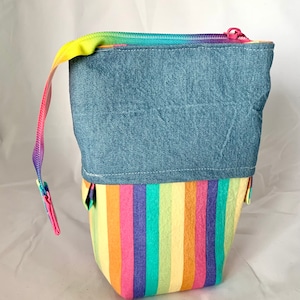 So clever! Pastel rainbow with denim sliding standing pen pouch.  Keep your writing tools close at hand, even on the go!