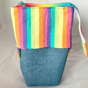 So clever! Pastel rainbow with denim sliding standing pen pouch.  Keep your writing tools close at hand, even on the go!