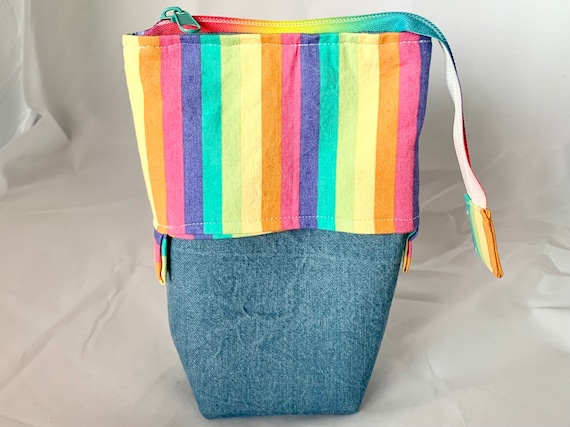 So clever! Pastel rainbow with denim sliding standing pen pouch.  Keep your writing tools close at hand, even on the go!