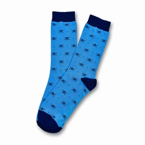 May include: A pair of blue socks with a navy blue skull and crossbones pattern.
