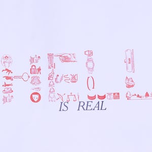 May include: A white poster with red illustrations and the words "HELL IS REAL". The illustrations include a variety of symbols, such as a hand, a key, a lock, and a watch. The poster is displayed outdoors.