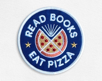 May include: A blue and white embroidered patch with the text "Read Books Eat Pizza" and a stylized image of a pizza slice with a book inside.