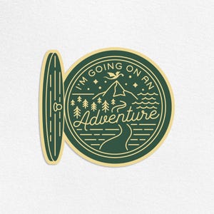 May include: A green and gold sticker with the text "I'm going on an Adventure". The sticker features a mountain, trees, and a river design. A surfboard-shaped sticker is next to the round sticker.