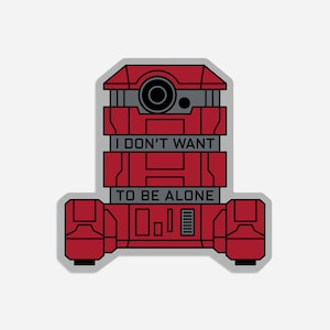 May include: A red robot sticker with the text "I DON'T WANT TO BE ALONE". The sticker has a gray border and a geometric design. The robot has a camera-like feature.