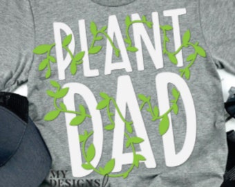 May include: Gray t-shirt with white text that says "Plant Dad" surrounded by green vines. The text is in a bold, playful font.