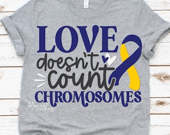 May include: Grey t-shirt with the text "LOVE doesn't count CHROMOSOMES" in blue and black lettering. A yellow and blue ribbon is on the right side of the shirt.