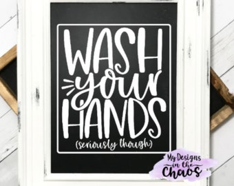 May include: White framed chalkboard sign with the text "Wash your hands (seriously though)" in white lettering on a black background. The sign has a distressed white frame and a small logo in the bottom right corner that says "My Designs in the Chaos".