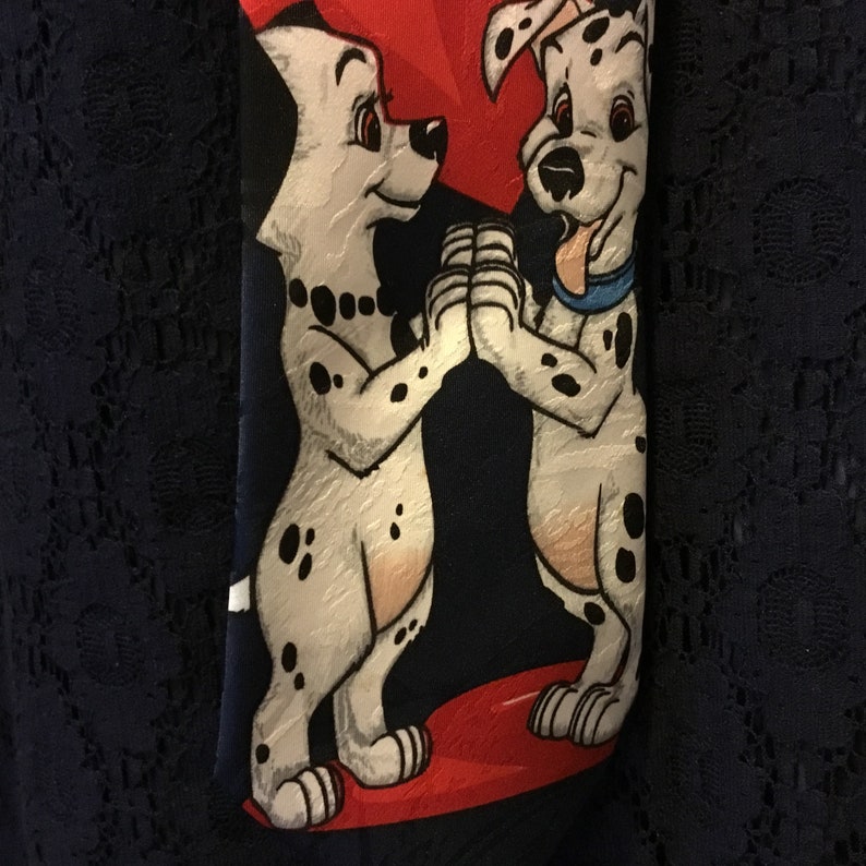 Great for valentines DISNEY 101 Dalmatians men\u2019s tie with Pongo and Perdetia clutching each other\u2019s paws while hearts bubble through them
