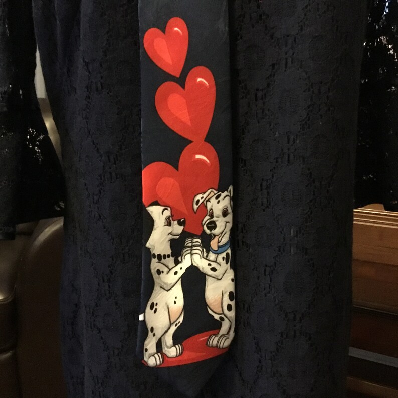 Great for valentines DISNEY 101 Dalmatians men\u2019s tie with Pongo and Perdetia clutching each other\u2019s paws while hearts bubble through them