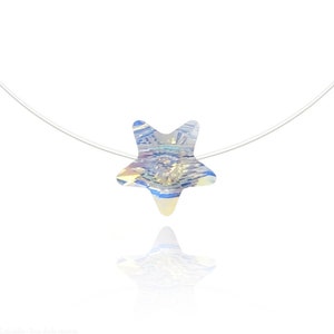 May include: A clear, thin chain necklace with a star-shaped crystal pendant. The crystal is iridescent and reflects light in shades of blue, yellow, and white.