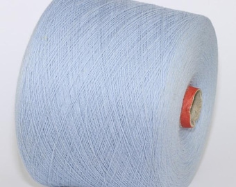 May include: A light blue skein of yarn wound on a cardboard bobbin.