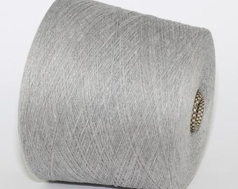May include: A skein of light grey yarn, wound into a cone shape.