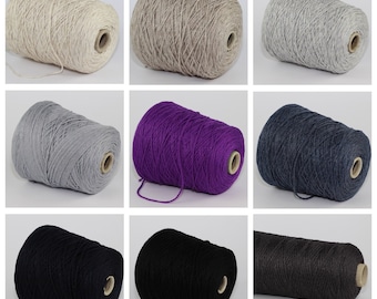 May include: Nine balls of yarn in a variety of colours, including beige, grey, purple, blue, black, and brown. The yarn is ready for knitting or crocheting.