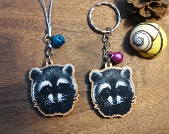 Keychain, charm or strap of a watercolor Raccoon portrait with grabby hands printed on wood