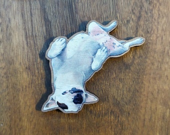 Magnet of a White English Bull Terrier chilling on its back printed on wood