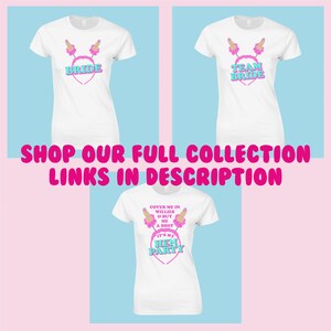 May include: Three white t-shirts with pink and blue text and graphics. The shirts say "Bride", "Team Bride", and "Cover me in willies & buy me a shot. It's my hen party".