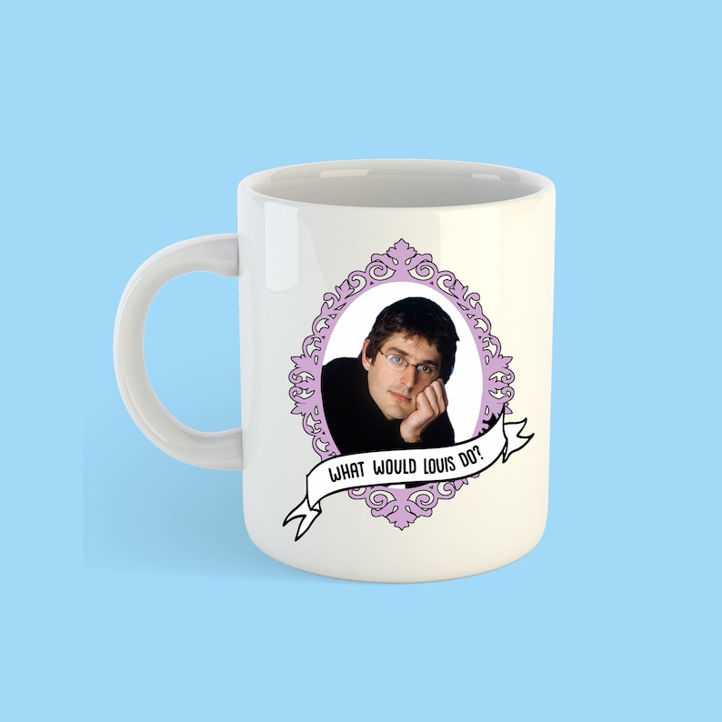 May include: White ceramic mug with a pink ornate frame featuring a photo of Louis CK. The text "What would Louis do?" is printed on a pink banner below the frame.