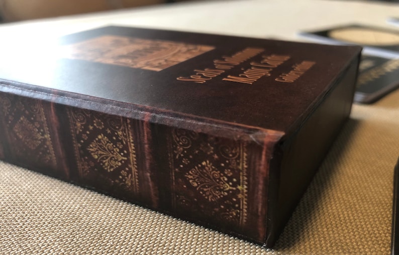 May include: A brown leather-bound box with gold accents and the text "Seals of Governance Major Cities" on the top.