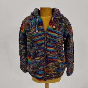May include: A colorful striped hooded sweater with a zipper closure. The sweater is made of a soft, knitted fabric and features a variety of colors, including blue, green, red, orange, and yellow.