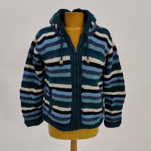 May include: A striped hooded sweater with a zipper closure. The sweater is made of a soft, knitted fabric and features a variety of colors, including blue, green, white, and black.