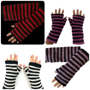 May include: Four pairs of striped fingerless gloves. The gloves are black and red, black and purple, black and white, and black and light purple.