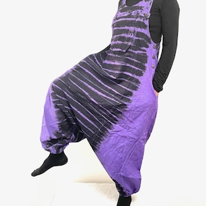 May include: Purple and black tie-dye jumpsuit with a wide leg and a button closure on the side.
