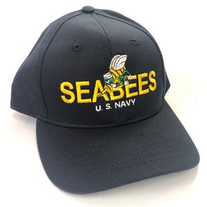 May include: A black baseball cap with a yellow embroidered bee and the text "SEABEES U.S. NAVY".
