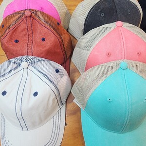 May include: Five different colored baseball caps with mesh panels. The caps are in various colors including pink, red, black, coral, and turquoise.