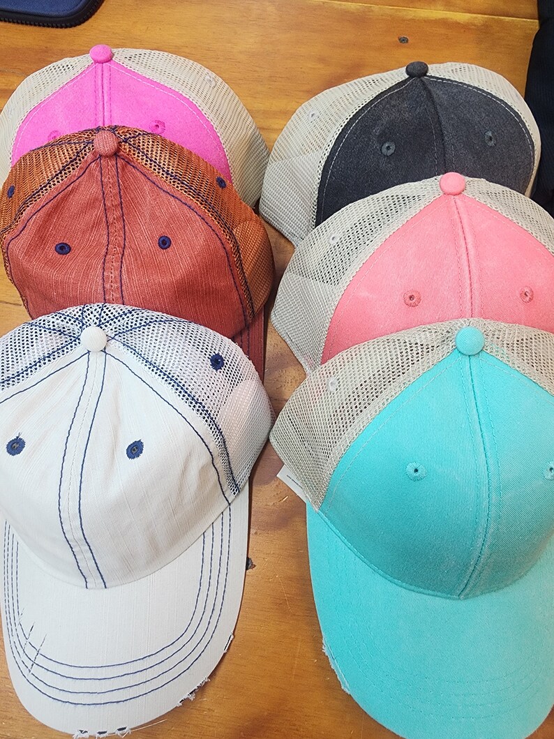 May include: Five different colored baseball caps with mesh panels. The caps are in various colors including pink, red, black, coral, and turquoise.