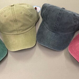 Puede incluir: Cuatro gorras de b&eacute;isbol lisas en diferentes colores: verde, caqui, azul y burdeos.