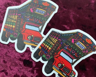 May include: Two colorful truck stickers with intricate patterns and the Arabic phrase "Masha Allah" on the side. The trucks are red with white wheels and a white background.