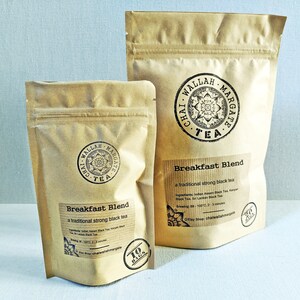 May include: Two brown paper bags of Chai Wallah Margate tea. The larger bag has a label that says "Breakfast Blend, a traditional strong black tea". The smaller bag has a label that says "Breakfast Blend, a traditional strong black tea" and "10 bags".