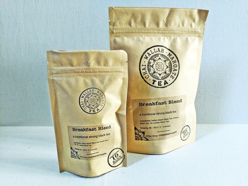 May include: Two brown paper bags of Chai Wallah Margate tea. The larger bag has a label that says "Breakfast Blend, a traditional strong black tea". The smaller bag has a label that says "Breakfast Blend, a traditional strong black tea" and "10 bags".