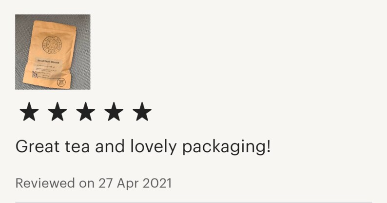 May include: A five-star review with the text "Great tea and lovely packaging!" and "Reviewed on 27 Apr 2021". The image shows a brown paper bag with a logo and text on it.