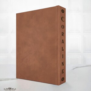 spine detail Coraline handcrafted hardcover with decorative elements,
back cover of minimalist Coraline rebound edition neutral aesthetic