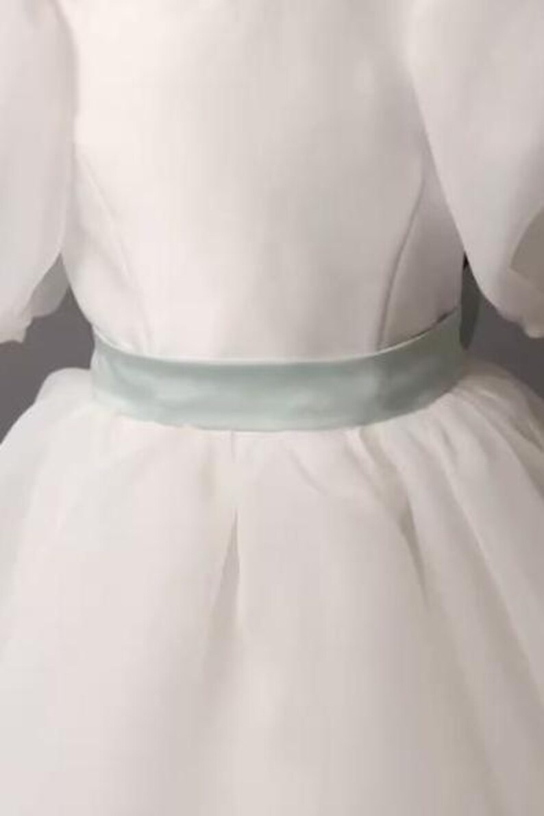 personalized first communion dress, custom flower girl dress, embroidered belt dress, first holy communion outfit, heirloom dress for girls, embroidered sash dress, ivory dress with monogram, white dress with big bow, special occasion dress girl, birthday dress with embroidered sash, wedding dress for young girls, flower girl dress with ribbon bow, baptism dress with embroidered belt