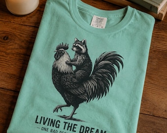 Raccoon Riding Rooster Living the Dream T-shirt | Funny Animal Illustration