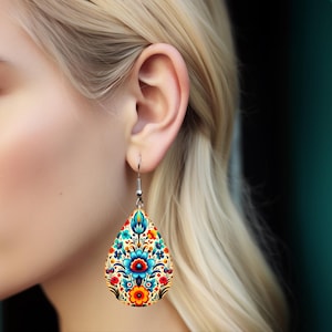 May include: A pair of teardrop-shaped earrings with a colorful floral pattern. The earrings are made of wood and have a silver hook.
