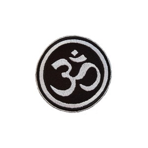 May include: White embroidered Om symbol on a black circular patch with a white border.